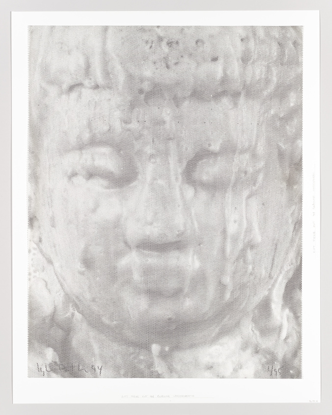Close-up of a serene Buddha face made with a halftone dot pattern.