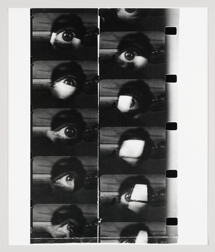 A black and white contact sheet featuring multiple close-up images of a person's eye and eyebrow, with some frames showing the eye partially covered by a square object. The film strip has visible sprocket holes along the right edge.
