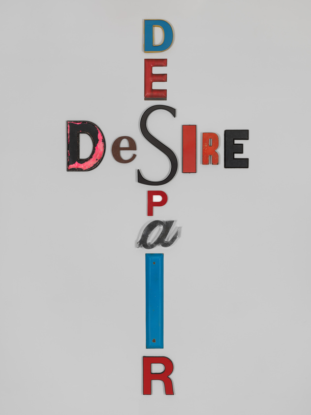 Colorful letters arranged vertically to spell "DESIRE" and "DESPAIR" with shared "DE," against a white background.