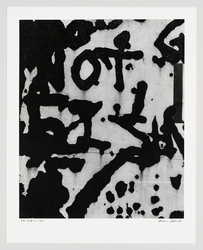 Black and white abstract artwork featuring bold, irregular black shapes and forms on a white background, resembling a graffiti-like composition. The image includes text at the bottom indicating the location and year "New York 1951" on the left and a signature on the right.