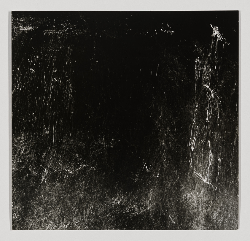 A monochrome abstract artwork with dynamic white scratches and lines on a dark background, creating a sense of movement and chaos.