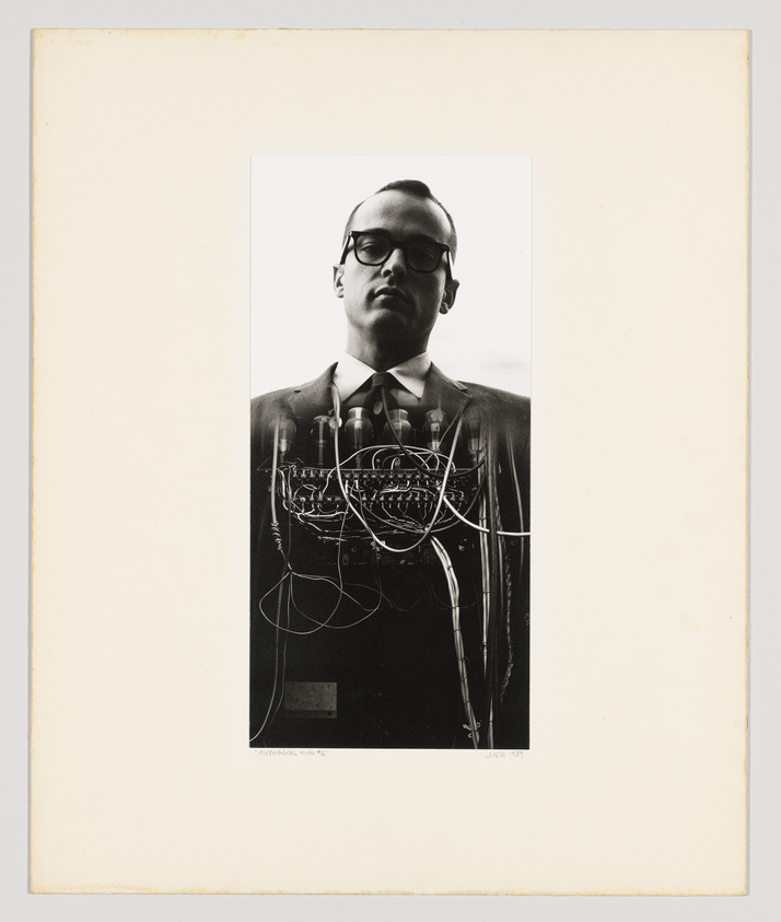 Black and white photo of a man with glasses and a suit, overlaid with an intricate circuit-like design.