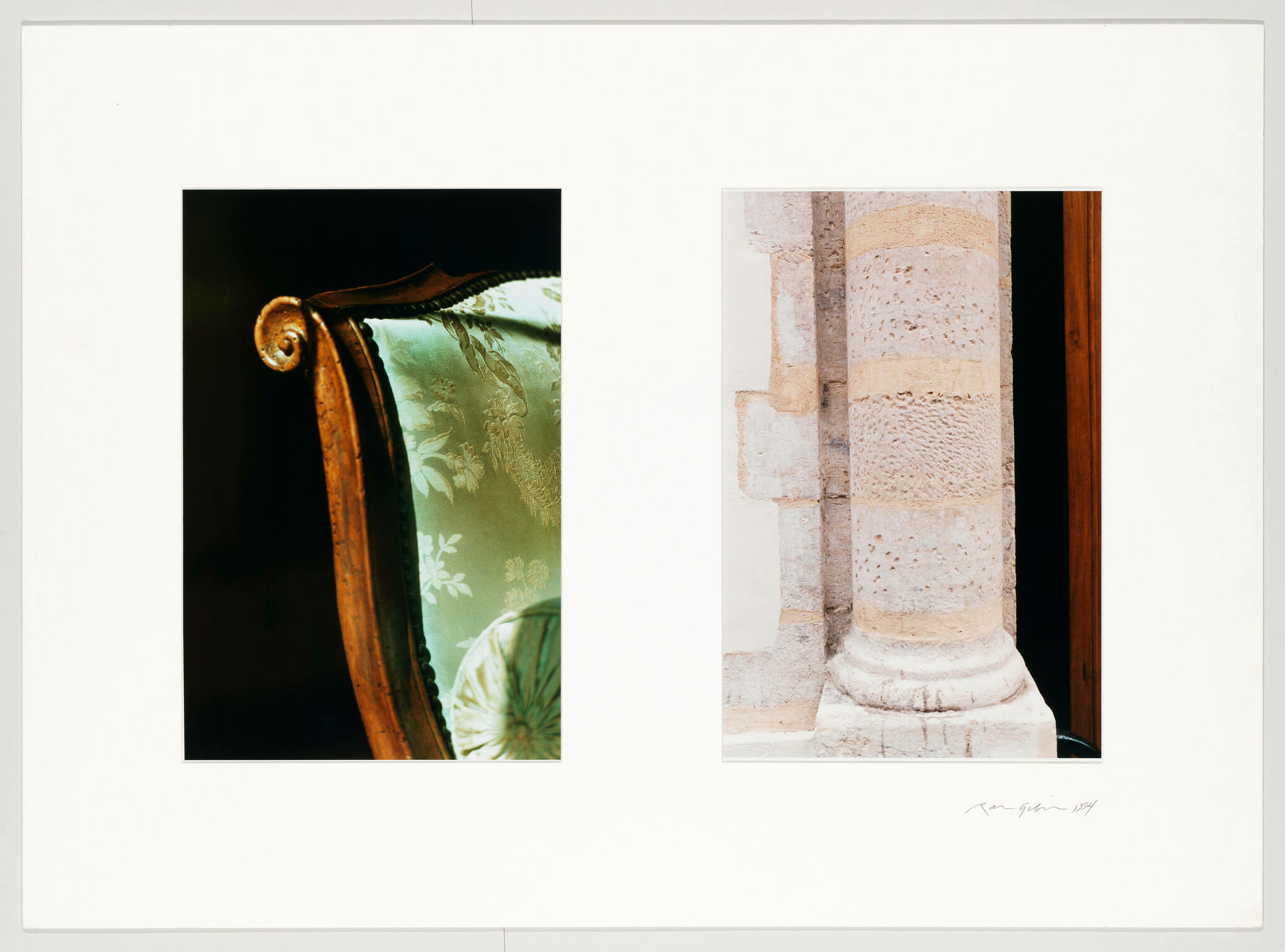Two framed photographs are displayed side by side against a white background. The left photo features a close-up of an ornate wooden chair arm with a scrolled end, against a dark background with a hint of a green upholstered fabric with a floral pattern. The right photo shows a close-up of a textured stone column, part of a classical architectural structure, with a glimpse of a dark interior space visible through a gap. The images are signed by the artist at the bottom right.