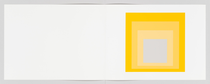 Open book with concentric squares in yellow and gray on right page.