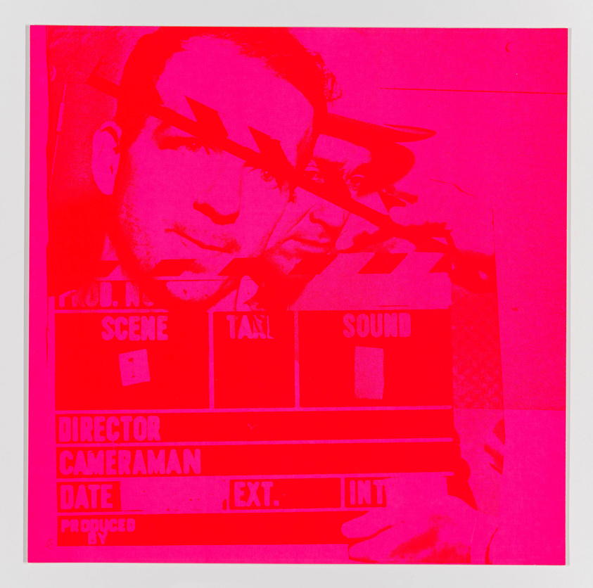 A vivid pink and red monochromatic image featuring a double exposure effect with a man's face and a clapperboard in the foreground. The text on the clapperboard includes typical film production details such as "SCENE," "TAKE," "DIRECTOR," "CAMERAMAN," but the specific information is not filled in. The overlapping visuals create an abstract and artistic composition.