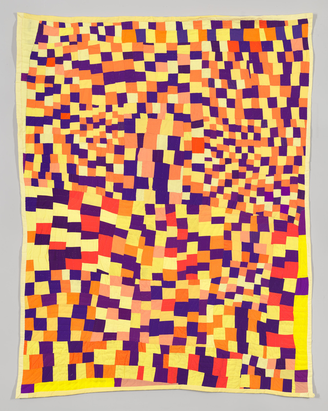 Colorful geometric quilt with a vibrant mosaic of purple, orange, and yellow squares.