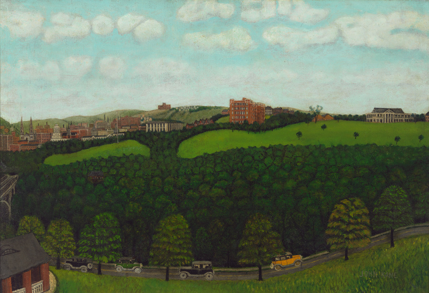 A painting depicting a lush, green landscape with a variety of trees in the foreground and a cityscape in the distance. The sky is filled with fluffy white clouds, and there is a road winding through the trees with vintage cars. The buildings in the distance show architectural diversity, suggesting an urban environment behind the natural setting. The artist's signature, "JOHN KANE," is visible in the lower right corner.