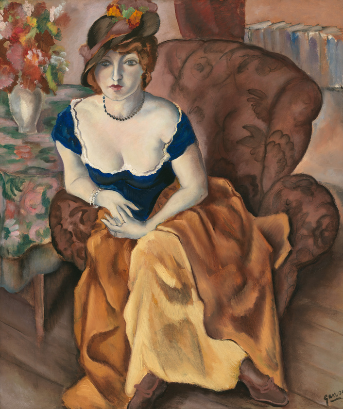 A painting depicting a seated woman with a thoughtful expression, wearing a blue dress with white lace trim and a hat adorned with flowers. She is seated on a plush, patterned armchair, with a vase of flowers and a floral arrangement in the background. The woman's hands are gently folded in her lap, and she wears a pearl necklace and a bracelet, adding to the elegance of the scene. The warm and rich colors give the painting a cozy, intimate atmosphere.
