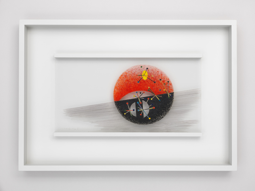 Framed artwork featuring a textured, half red, half black circle with colorful abstract patterns, resembling a molecular structure, set against a white background with a grey horizontal brushstroke. The piece is signed in the lower left corner.