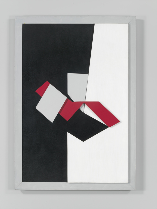 A framed abstract geometric painting featuring a stark contrast between black and white areas, with a central composition of overlapping red and white shapes on a black background. The artwork is mounted on a wall and encased in a simple white frame.