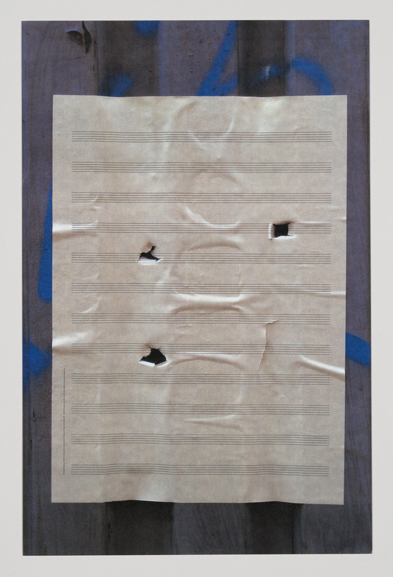 A piece of crumpled sheet music with several tears and holes is centered against a textured background with dark and blue hues.