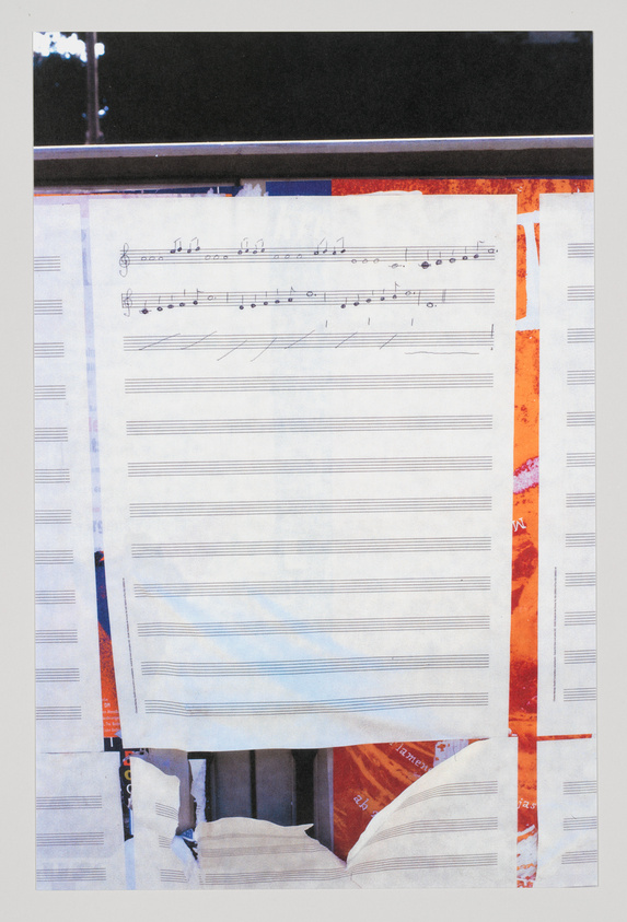 A collage featuring musical notation on a sheet of paper with several empty staves, overlaid on a background that includes torn pages and fragments of text, with a hint of an urban scene at the top edge.