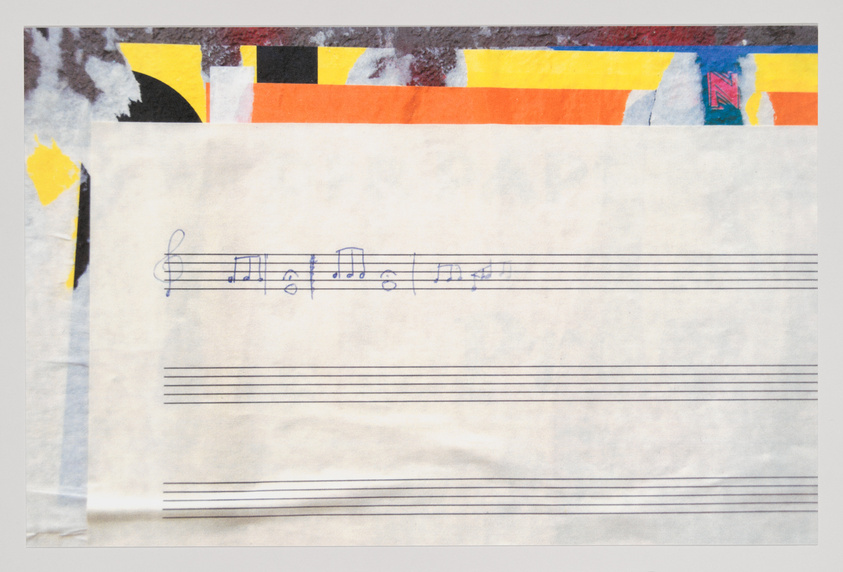 A piece of paper with musical notation is overlaid on a colorful abstract background. The musical staff contains a clef and several notes, suggesting a snippet of a musical composition. The background shows a collage of different shapes and colors, including yellow, black, orange, and red, with some text elements partially visible.