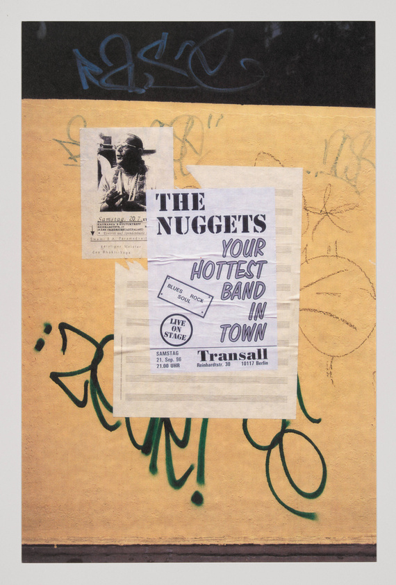 A textured artwork featuring a collage of posters and graffiti. The top section has a black background with blue graffiti, while the bottom section is a mustard yellow with green graffiti. Central posters advertise a band called "THE NUGGETS" as the "HOTTEST BAND IN TOWN" with performance details, and another smaller poster shows a person playing a saxophone. The piece has a gritty, urban feel.
