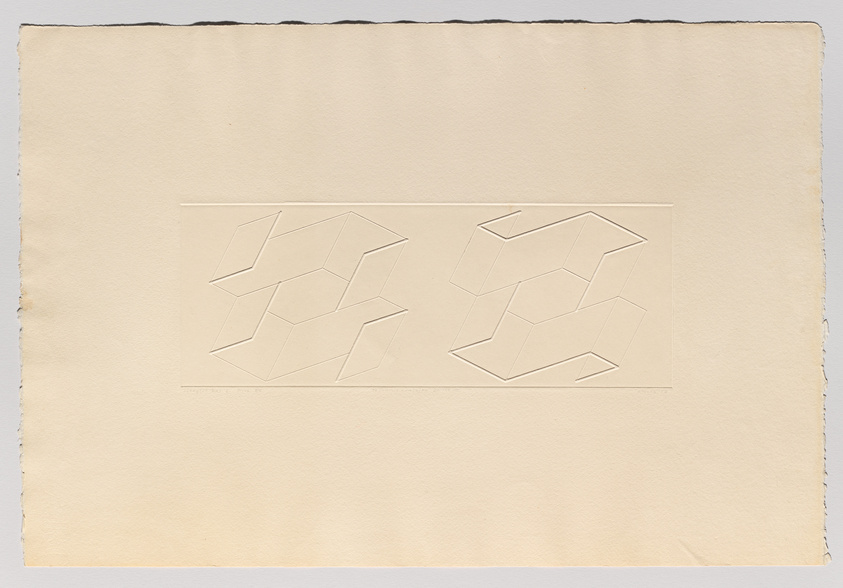 An aged paper with two embossed geometric shapes, resembling abstract three-dimensional cubes, positioned side by side in a horizontal orientation. The paper has rough edges and shows signs of wear.