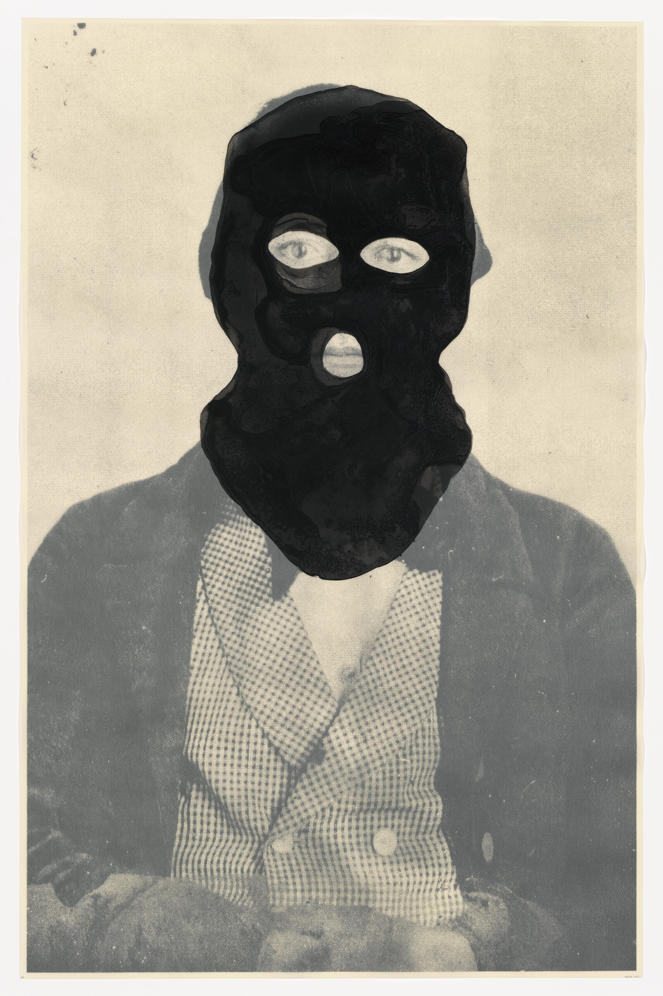 Vintage black and white photograph of a person wearing a houndstooth patterned suit with a ski mask obscuring their face, set against a plain background. The image has aged with some discoloration and spots.