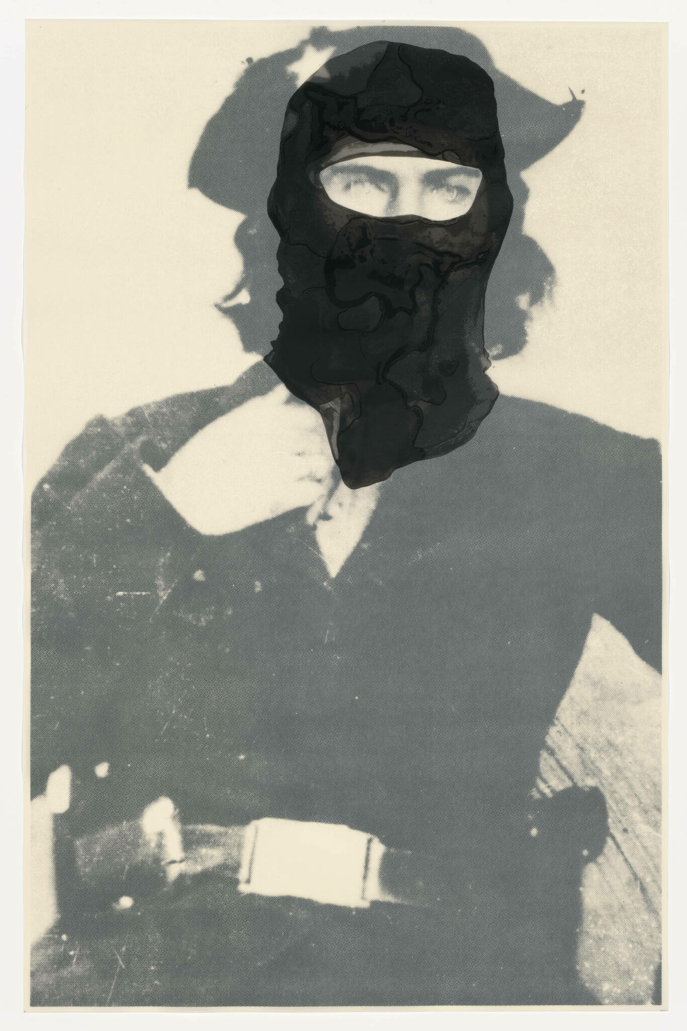 A vintage-looking photograph of a person wearing a balaclava with only their eyes visible. The image has a sepia tone and shows signs of wear and damage, with a large black blotch obscuring part of the face and head. The person's shadow is cast on a light background, suggesting bright sunlight.