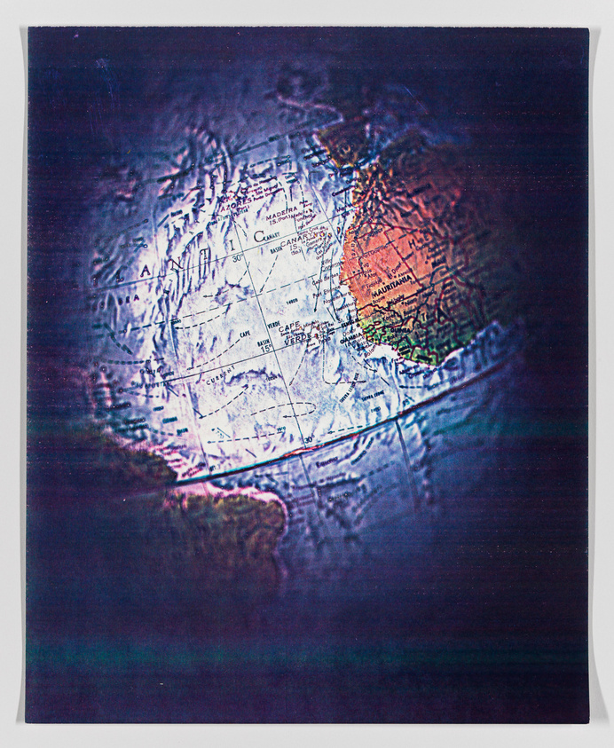 A distorted, colorful image of a globe focusing on the Atlantic Ocean with parts of Africa and Europe visible.