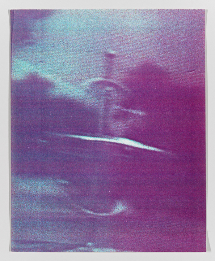 Blurry, abstract image with purple and blue hues, possibly depicting a distorted landscape or scene.