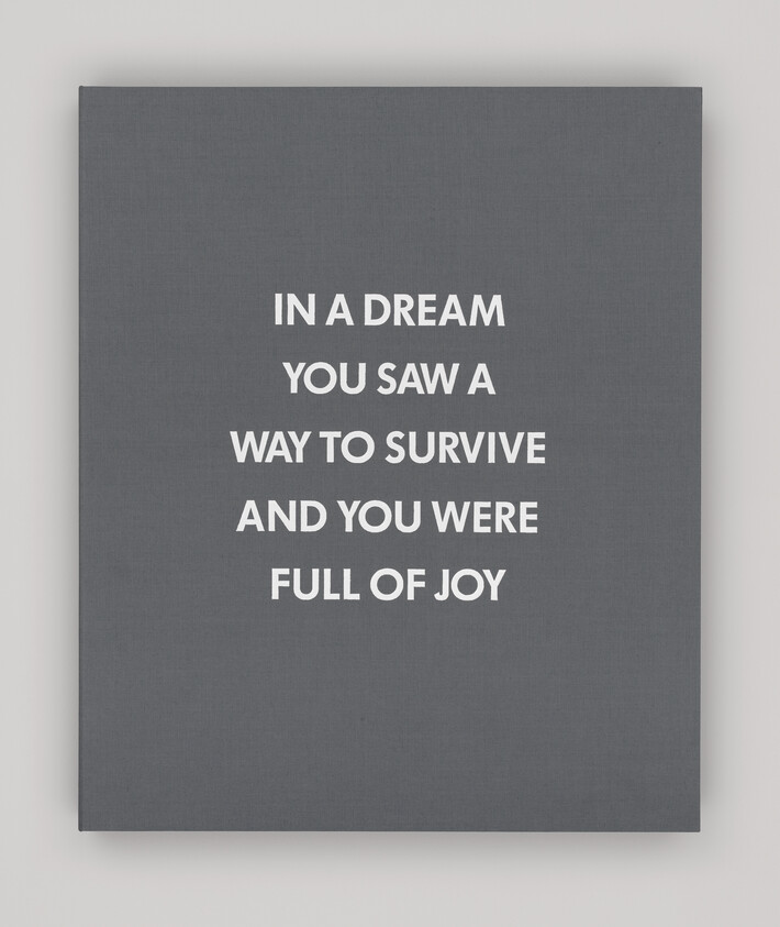 Gray canvas with white text: "IN A DREAM YOU SAW A WAY TO SURVIVE AND YOU WERE FULL OF JOY."