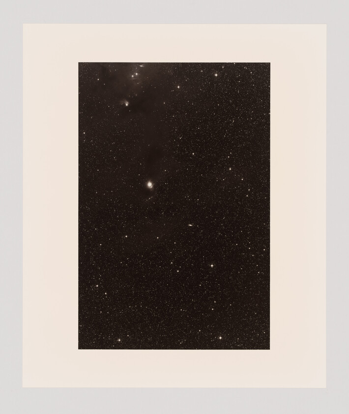 A dark sky filled with many small stars, with a few brighter spots scattered throughout.