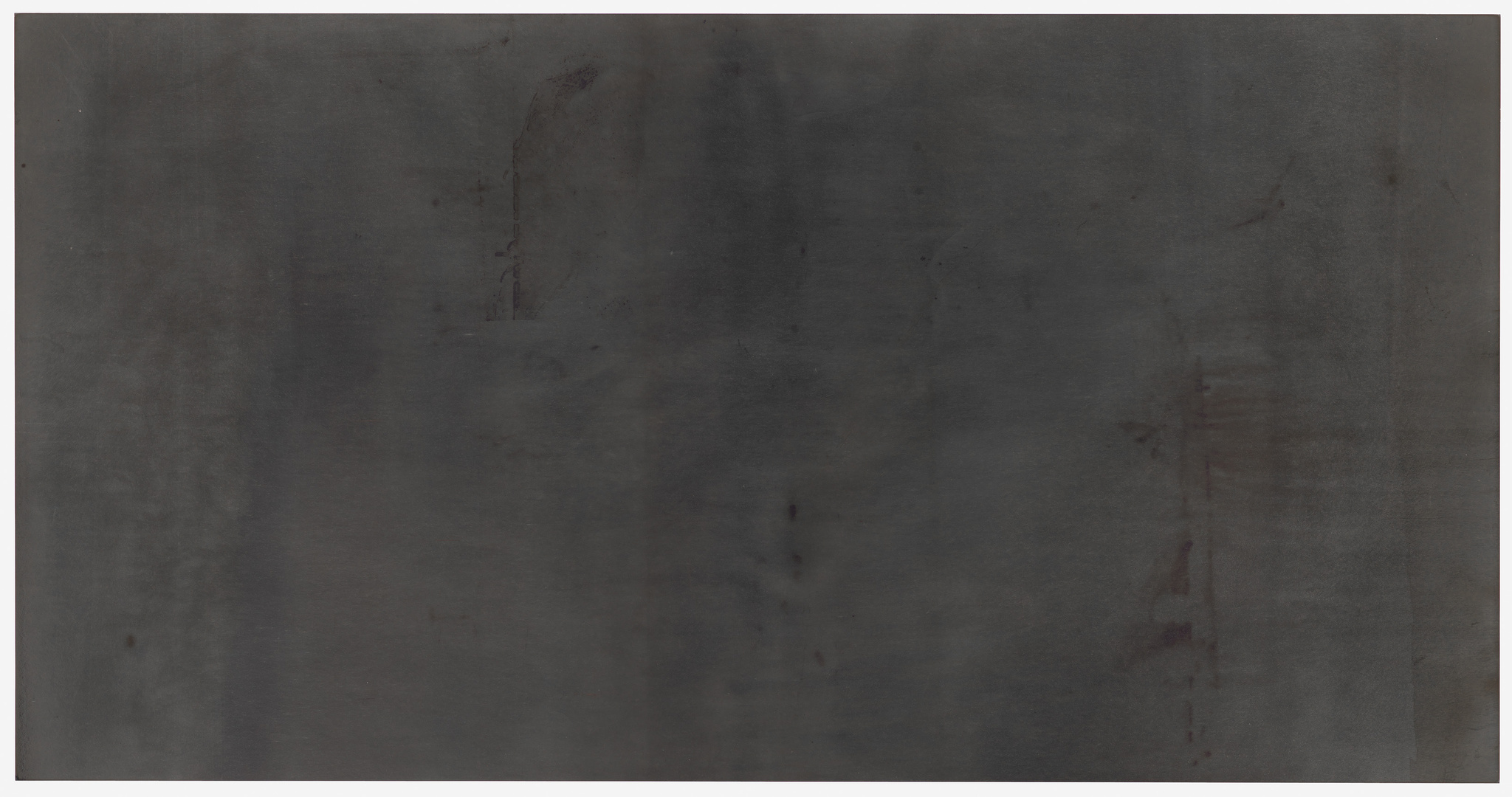 A large, monochromatic dark gray canvas with subtle variations in shade and a few indistinct marks and smudges throughout.