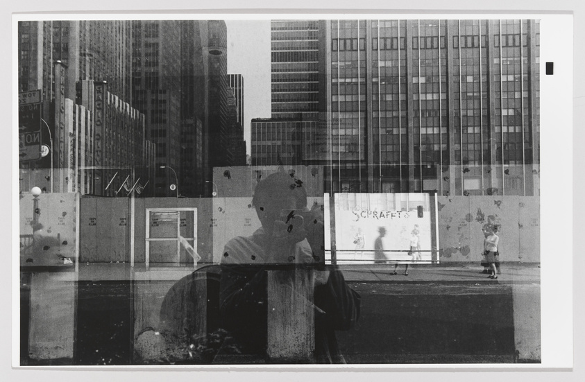 A black and white double exposure photograph capturing the bustling atmosphere of a city. The image overlays a close-up silhouette of a person's profile with a street scene featuring tall buildings, pedestrians, and construction barriers. The ghostly outline of the person's head and shoulders blends into the urban landscape, creating an intriguing visual effect that merges the human element with the architectural environment.