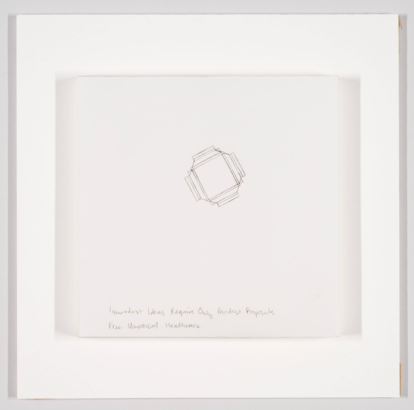 A minimalist drawing of a geometric shape resembling a cube centered on a white paper, with handwritten text at the bottom left corner. The paper is mounted on a white background with a subtle shadow indicating depth.