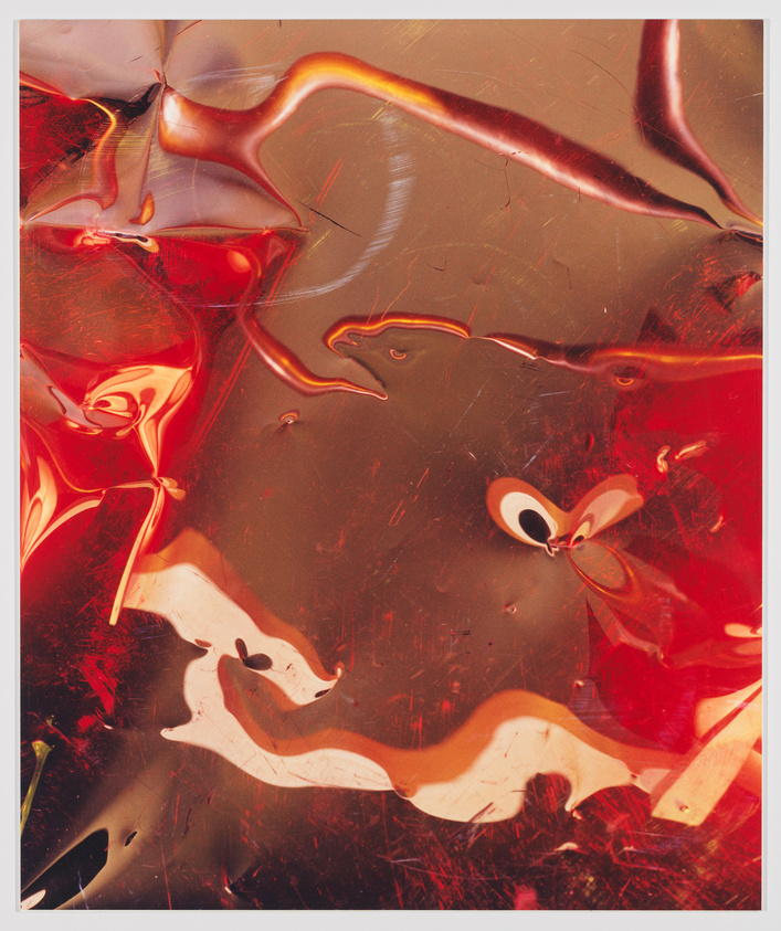 Abstract red and amber swirls with reflective surfaces creating a fluid, glass-like texture.