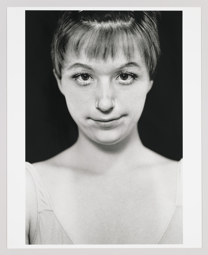 Black and white portrait of a young woman with short hair and a subtle smile.