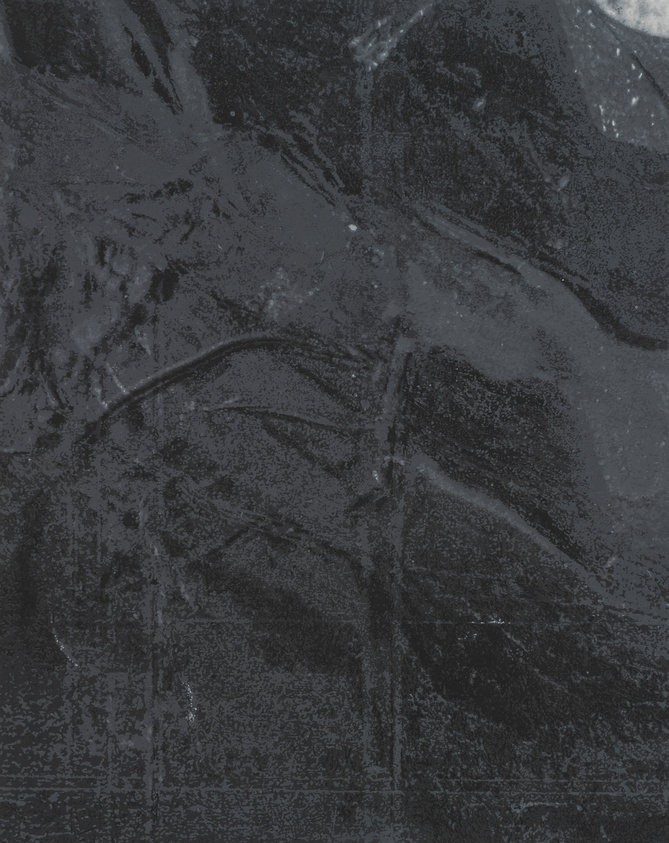 A close-up of a textured, black surface with subtle lines and speckles.