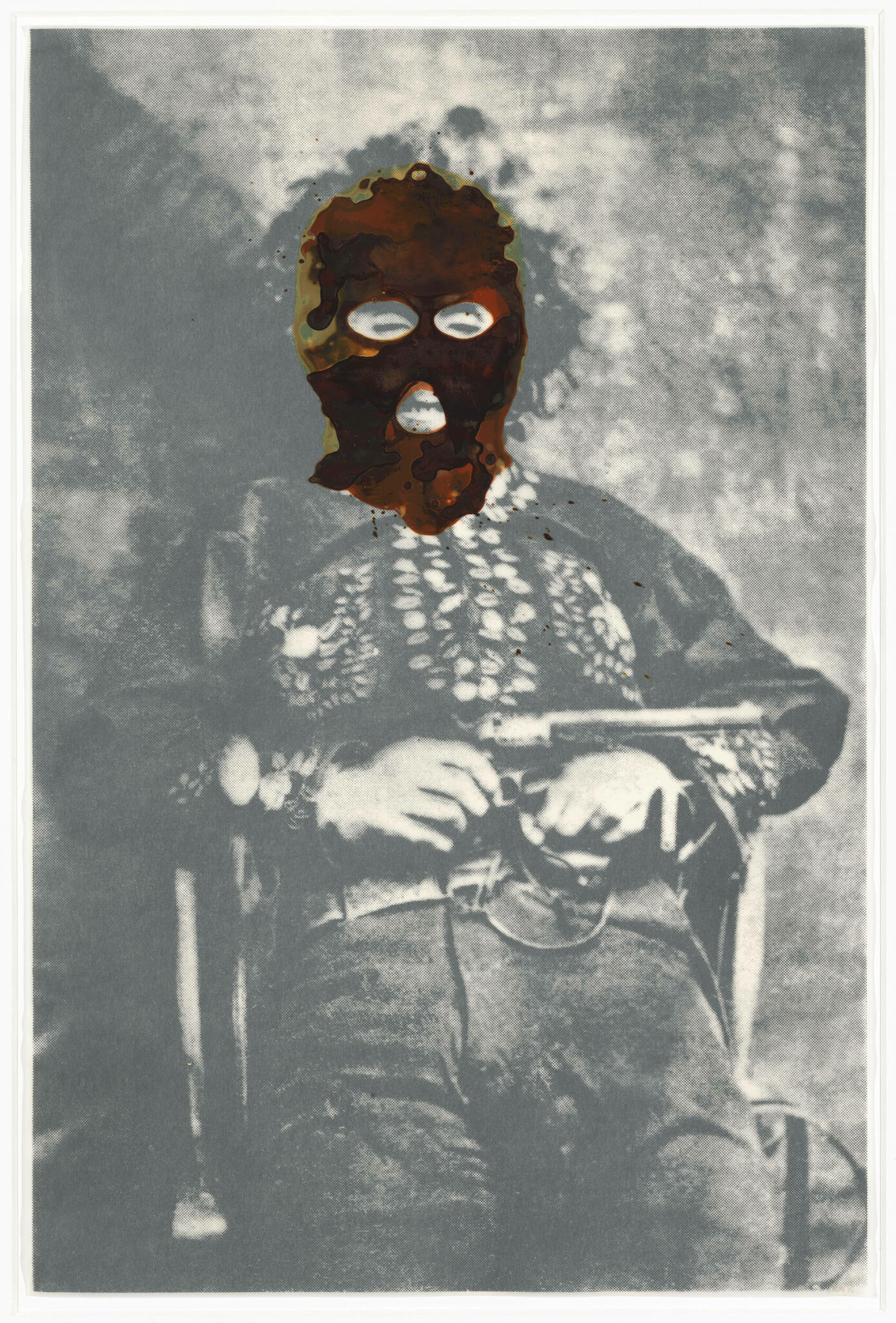 A vintage black and white photo of a person sitting in a chair with severe damage or alteration to the facial area, making the face unrecognizable. The person appears to be wearing period clothing and holding something in their lap. The photo has a textured, aged appearance with some discoloration.