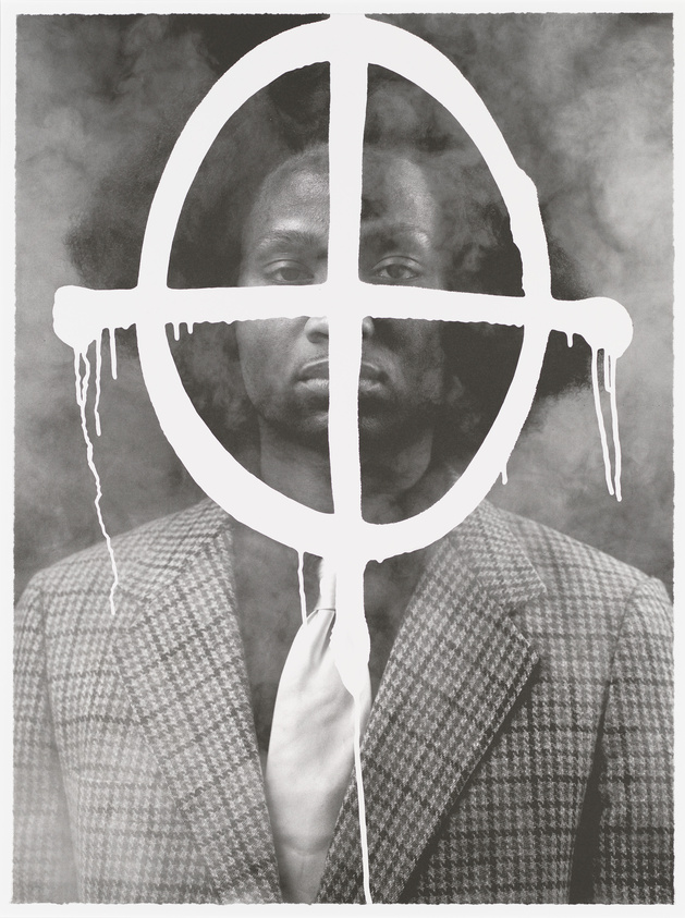 A monochrome image featuring a man in a houndstooth patterned suit and tie, with a serious expression. His face and upper body are overlaid with a white, dripping peace symbol, creating a stark contrast against the dark, smoky background.