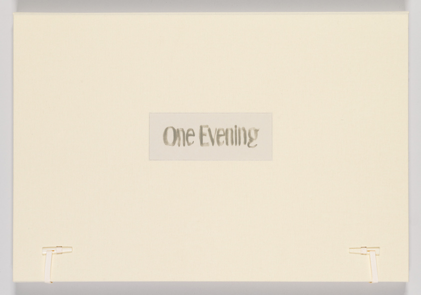 A minimalist artwork consisting of a cream-colored canvas with the phrase "One Evening" cut out in the center, revealing a shadowed background, and the canvas is mounted on a wall with two visible white mounting brackets on the lower corners.