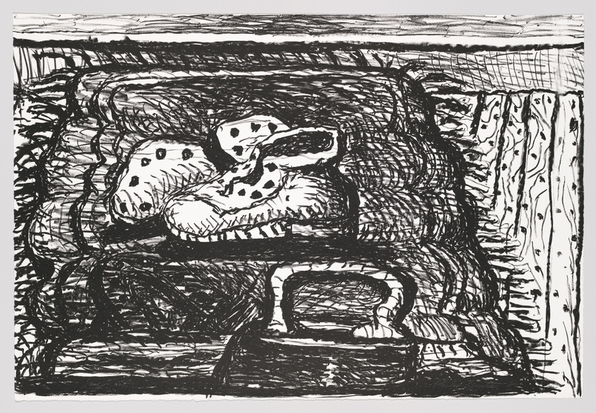 A patterned oven mitt rests on a textured surface with an iron placed in front of it.