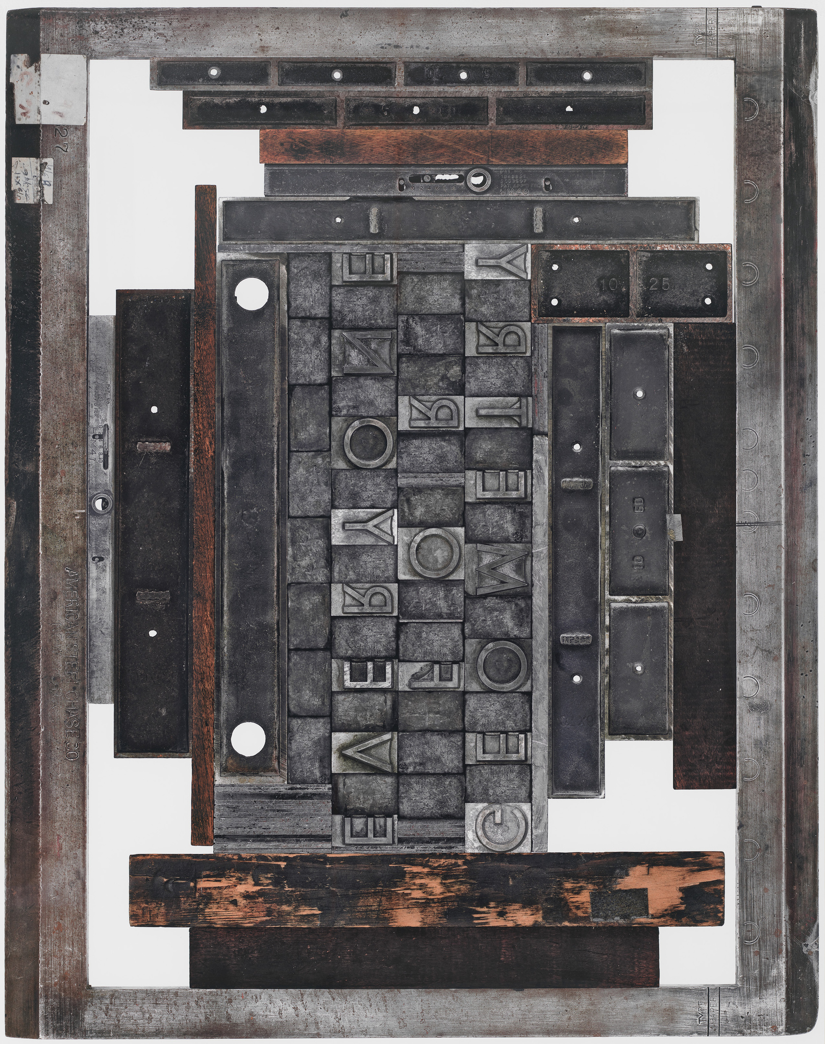 Vintage printing press letters and blocks arranged in a frame, creating an abstract composition.