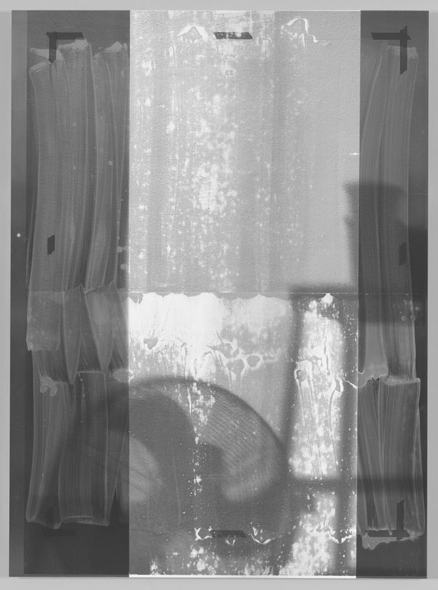 A grayscale image showing a set of three translucent curtains hanging in front of a window, with the middle curtain displaying signs of water damage or a pattern resembling a liquid spill. The image has a textured, vintage appearance, with light filtering through the fabric and casting soft shadows.