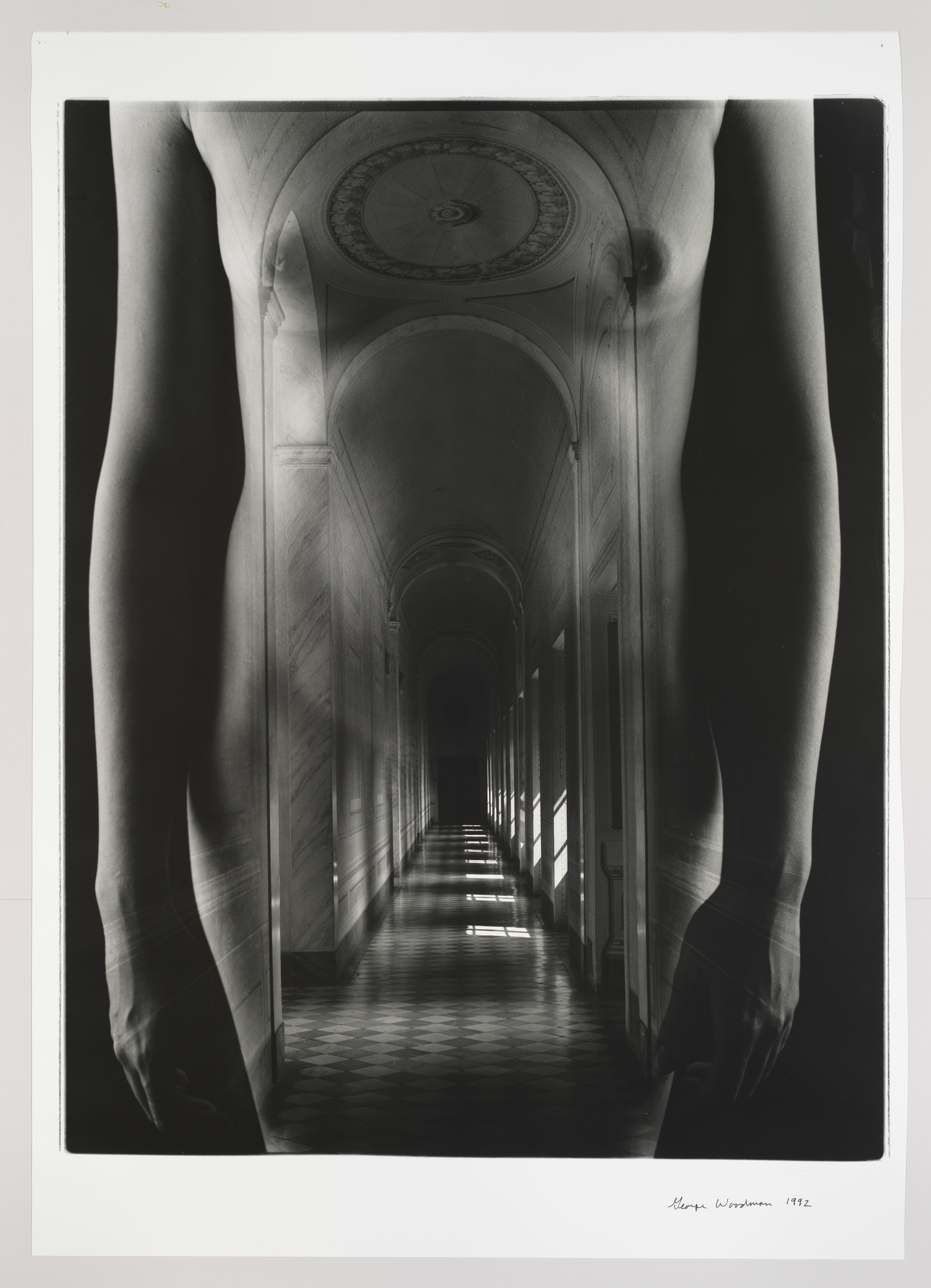 Black and white photo of a corridor overlaid with a transparent image of a person's legs, creating a surreal perspective.