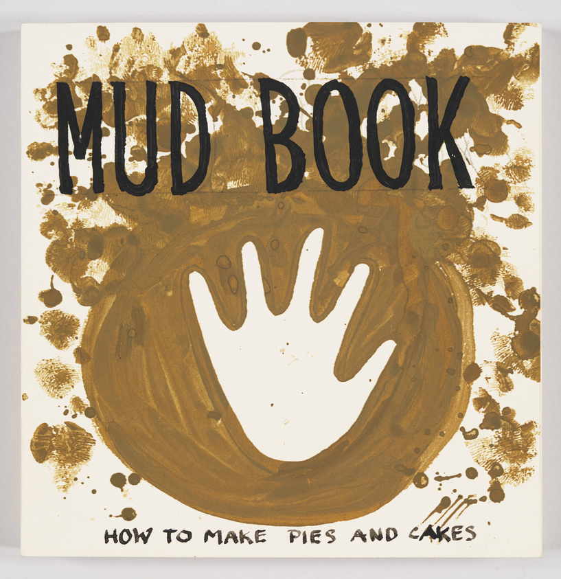 A playful book cover with the title "MUD BOOK" in bold, black letters at the top. Below is a large, brown handprint that resembles a mud print in the center, surrounded by various brown splatters and smudges. At the bottom, the subtitle "HOW TO MAKE PIES AND CAKES" is written in smaller black letters. The background is white, and the overall design mimics a messy, mud-splattered surface.