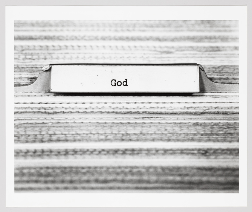 A file tab labeled "God" on a striped background.
