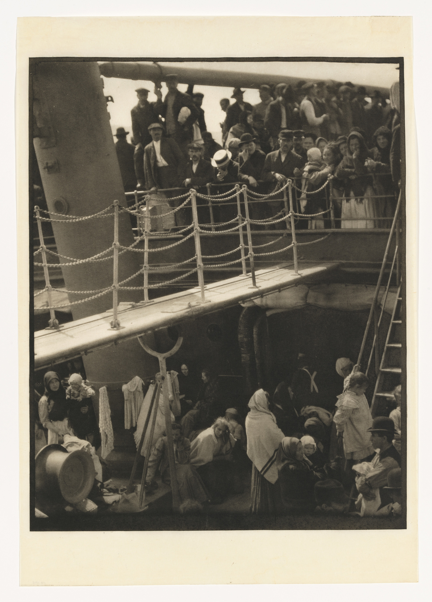 Vintage photo of passengers on ship decks, some standing by railings, others seated with belongings, evoking a journey.