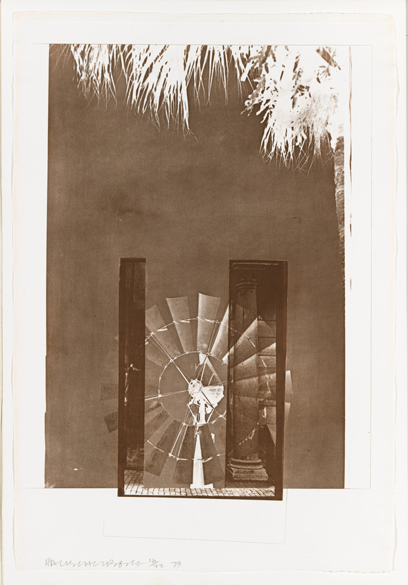 Sepia-toned photograph depicting a spiral staircase viewed through an open doorway, with a palm tree's fronds visible at the top edge. The image has a vintage appearance and includes a handwritten signature and date '79 in the lower margin.
