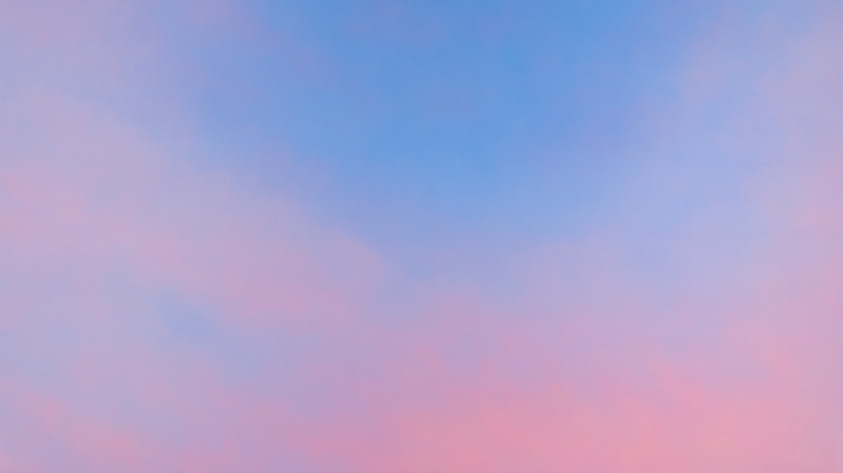 Soft blue and pink colors blend together in a clear sky, with no objects or text visible.