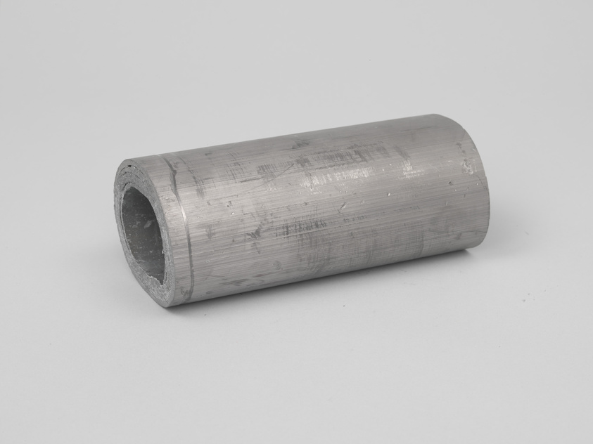 A cylindrical metal pipe with a brushed surface finish lying on a plain white background.