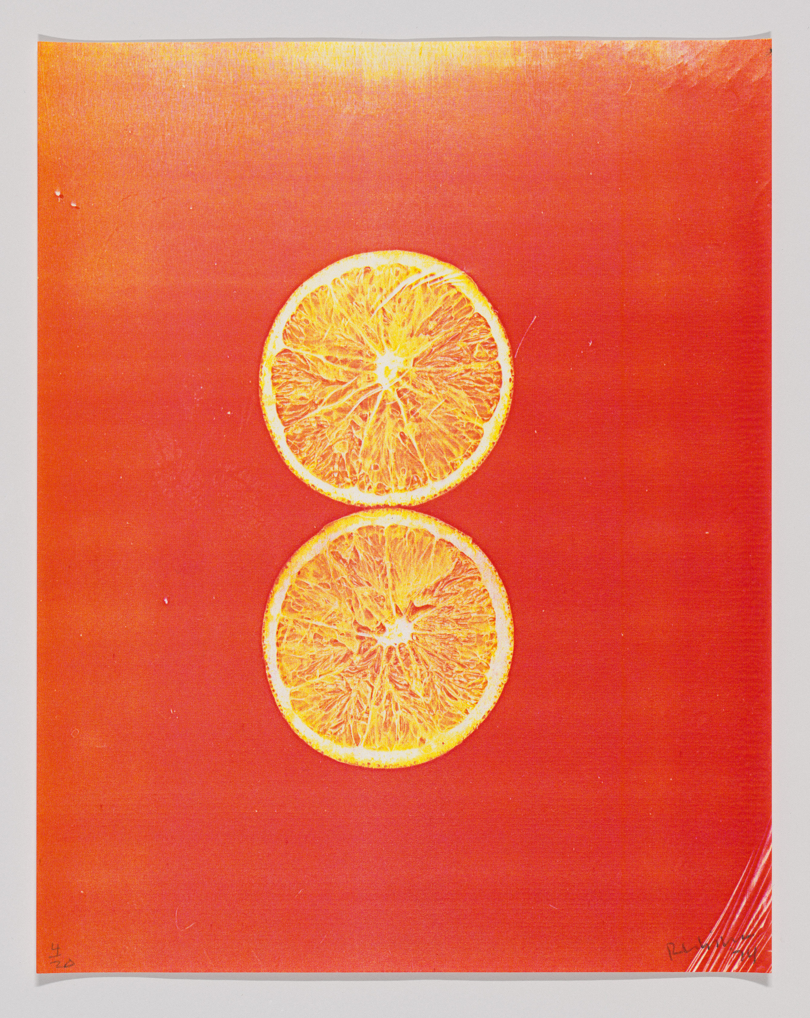 Two orange slices centered on a vibrant red background with a subtle texture.
