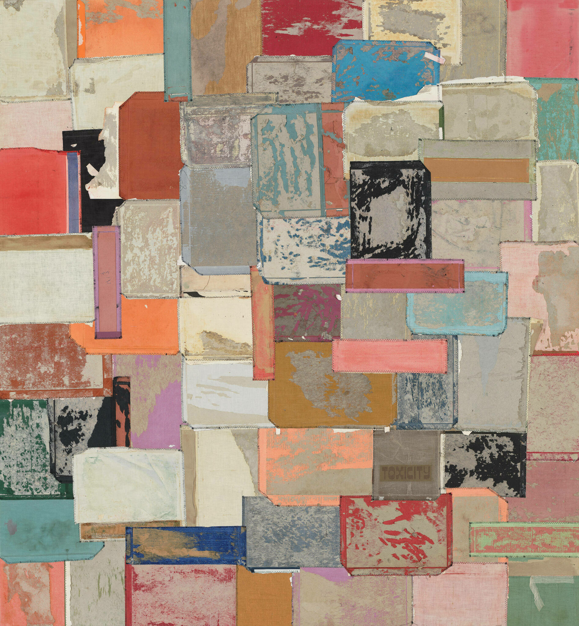 A textured collage of variously sized and colored rectangular patches arranged in an overlapping, abstract composition. The patches feature a mix of solid colors and patterns, with visible frayed edges and stitching, creating a rich, tapestry-like effect. One patch in the lower right corner has the word "TOXICITY" printed on it.