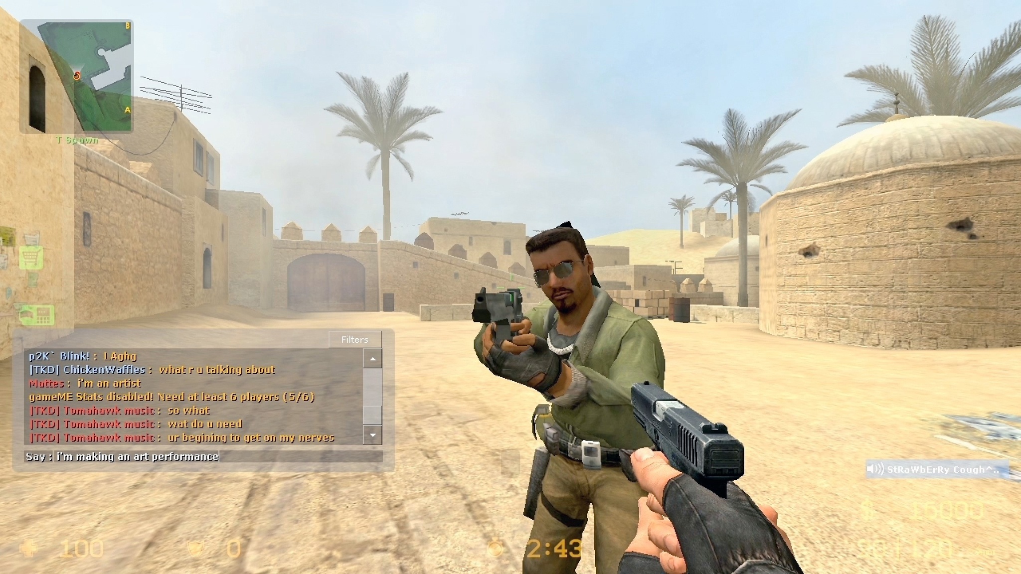 Two characters in a desert setting aim guns at each other, with chat messages displayed on screen.