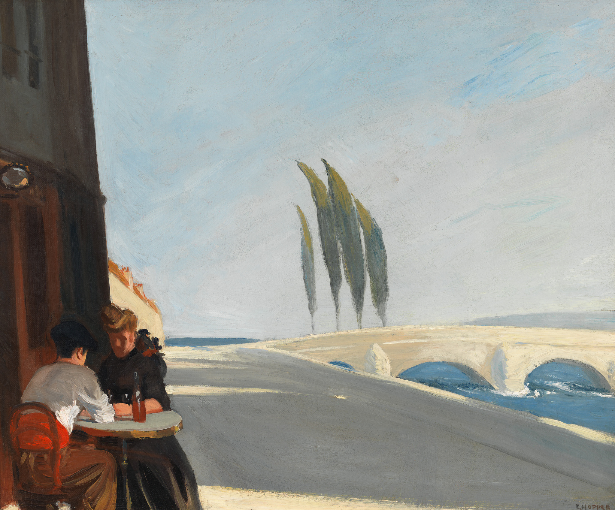 Oil painting depicting two people seated at a table outside a café, with a view of a bridge and a row of tall, slender trees in the background under a vast blue sky. The scene conveys a serene, almost desolate atmosphere. The signature "E. Hopper" is visible in the lower right corner.