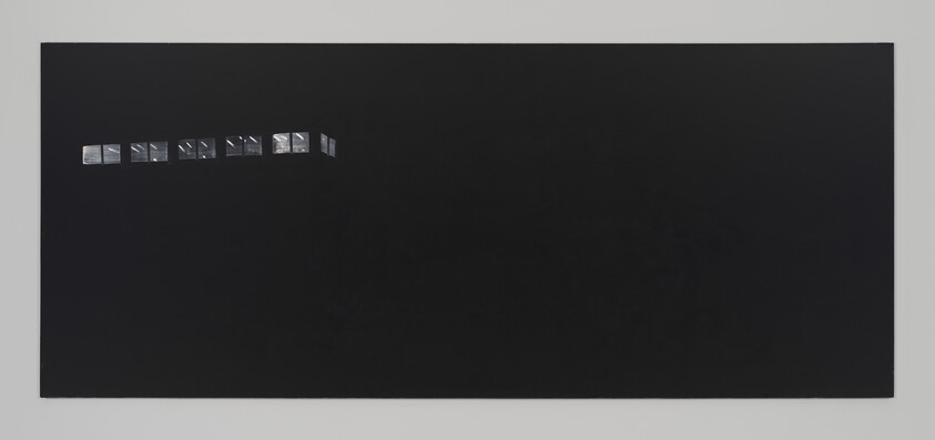 A mostly black canvas with a small row of lit windows in the upper left corner.