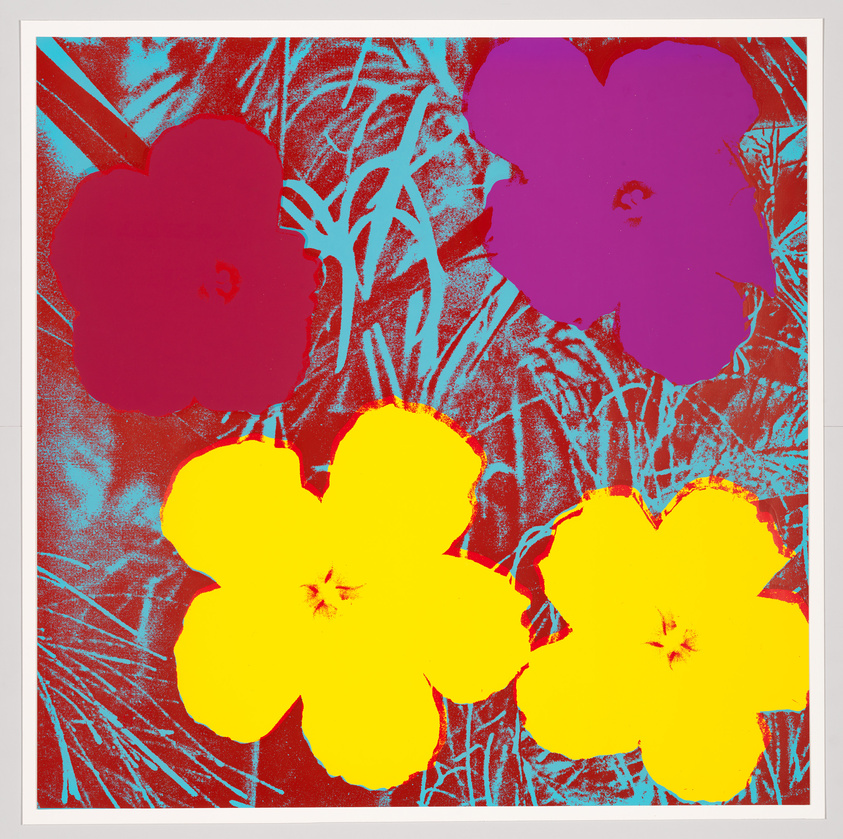 A vibrant pop art style image featuring a trio of large, brightly colored flowers in red, yellow, and purple against a textured turquoise and red background. The flowers have a simplistic, silhouetted look, reminiscent of screen printing techniques.